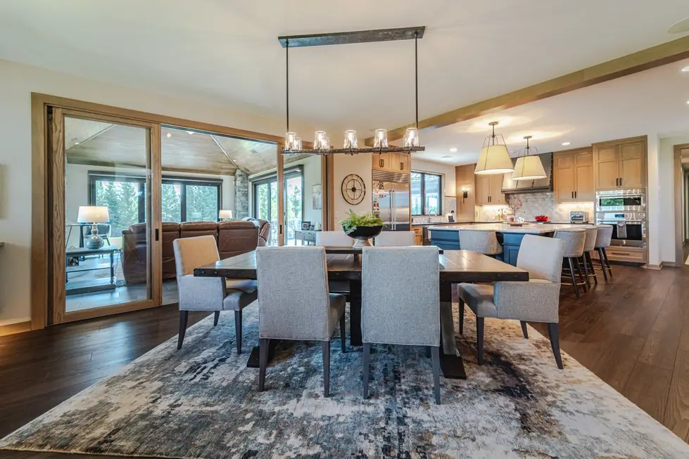 Open kitchen and dining remodel with dark hardwood flooring and a central island