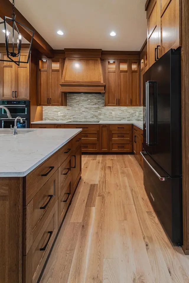 Transitional kitchen remodel by Avid Builders with traditional wood cabinetry and a tile backsplash