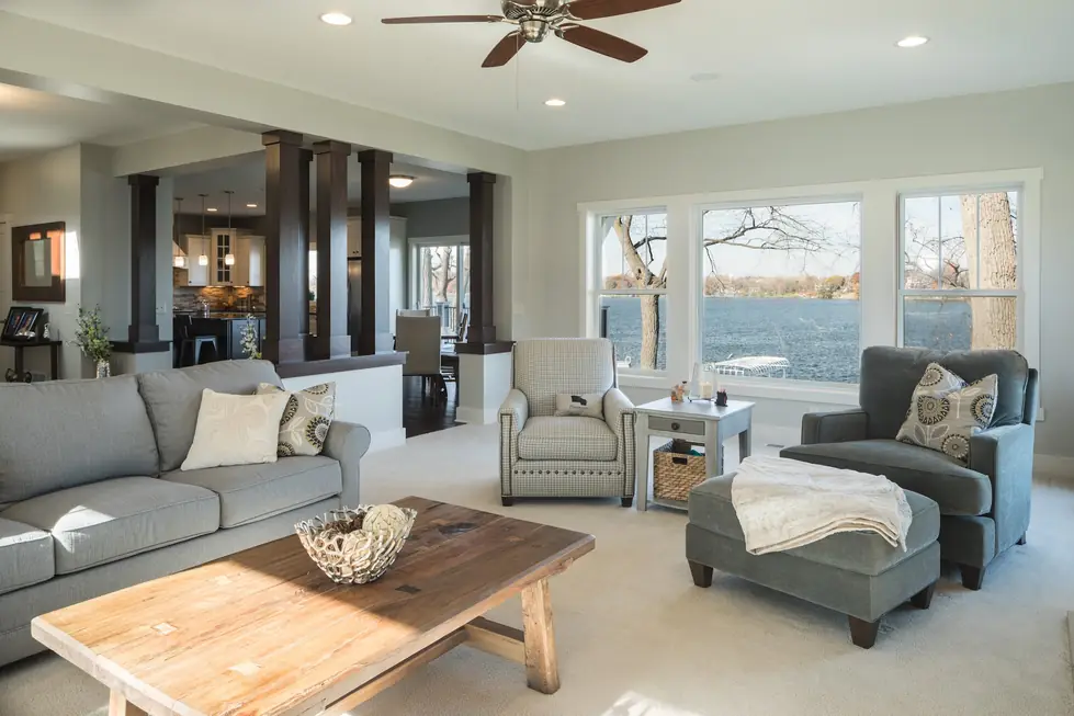 Lake-view living room remodel by Avid Builders, glazing running the full wall onto the water